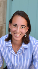 An image of Dana Fried against a blue backdrop
