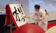 Shizu Usami performs calligraphy at the second annual Sakura-kai