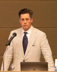 Paul Atkins speaking at a lectern