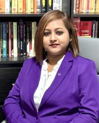 An image of Prof. Chowdhuri seated in front of a large bookcase.