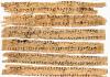 Strips of worn paper with Buddhist text